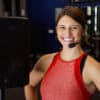 Happy fitness instructor wearing EVO-E Cableless headset mic